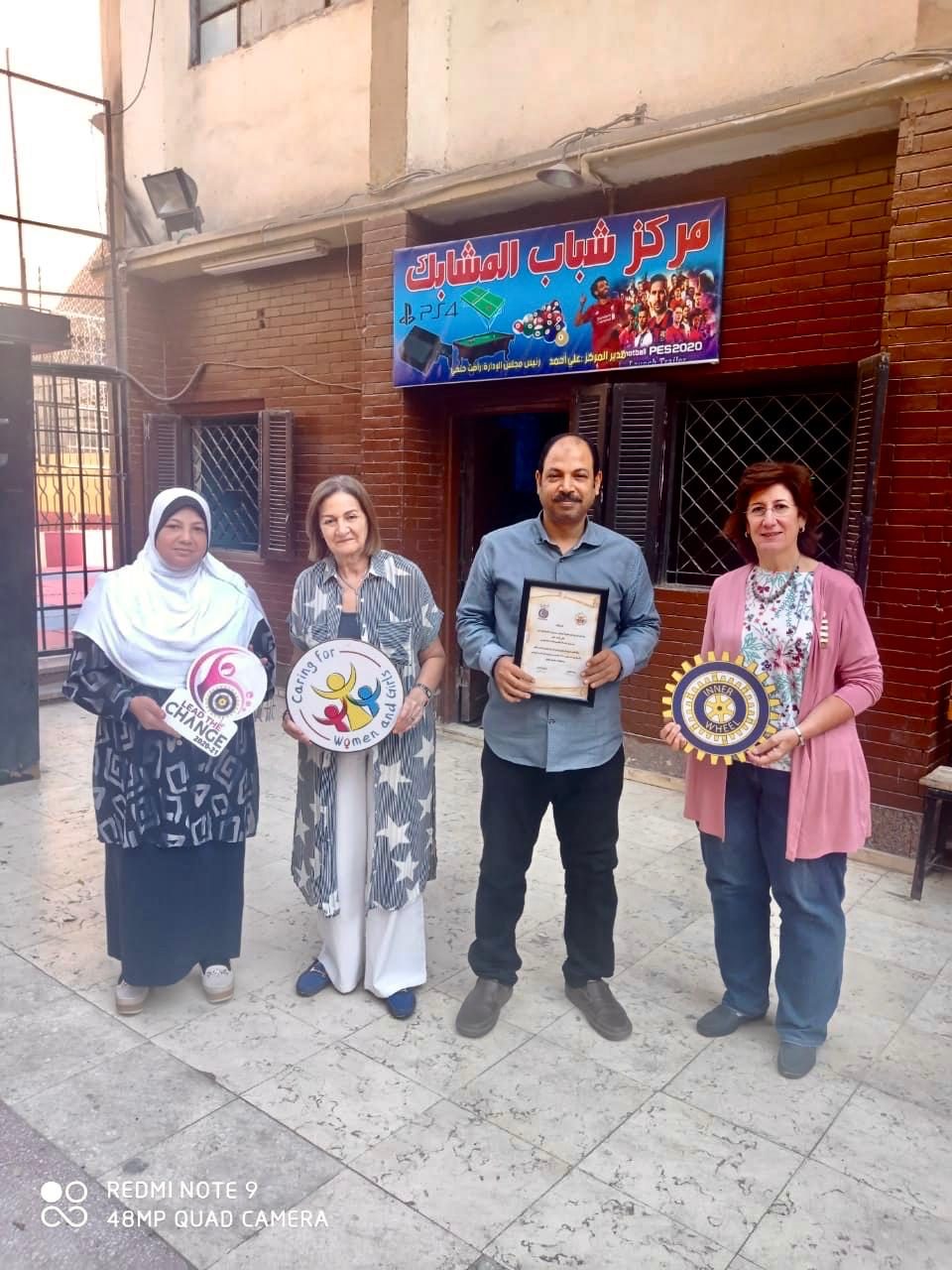 1-Mrs. Azza El Mofti & Mrs. Nihal El Rafeii Presents a certificate of Appreciation & Recognition to the trainer of sewing