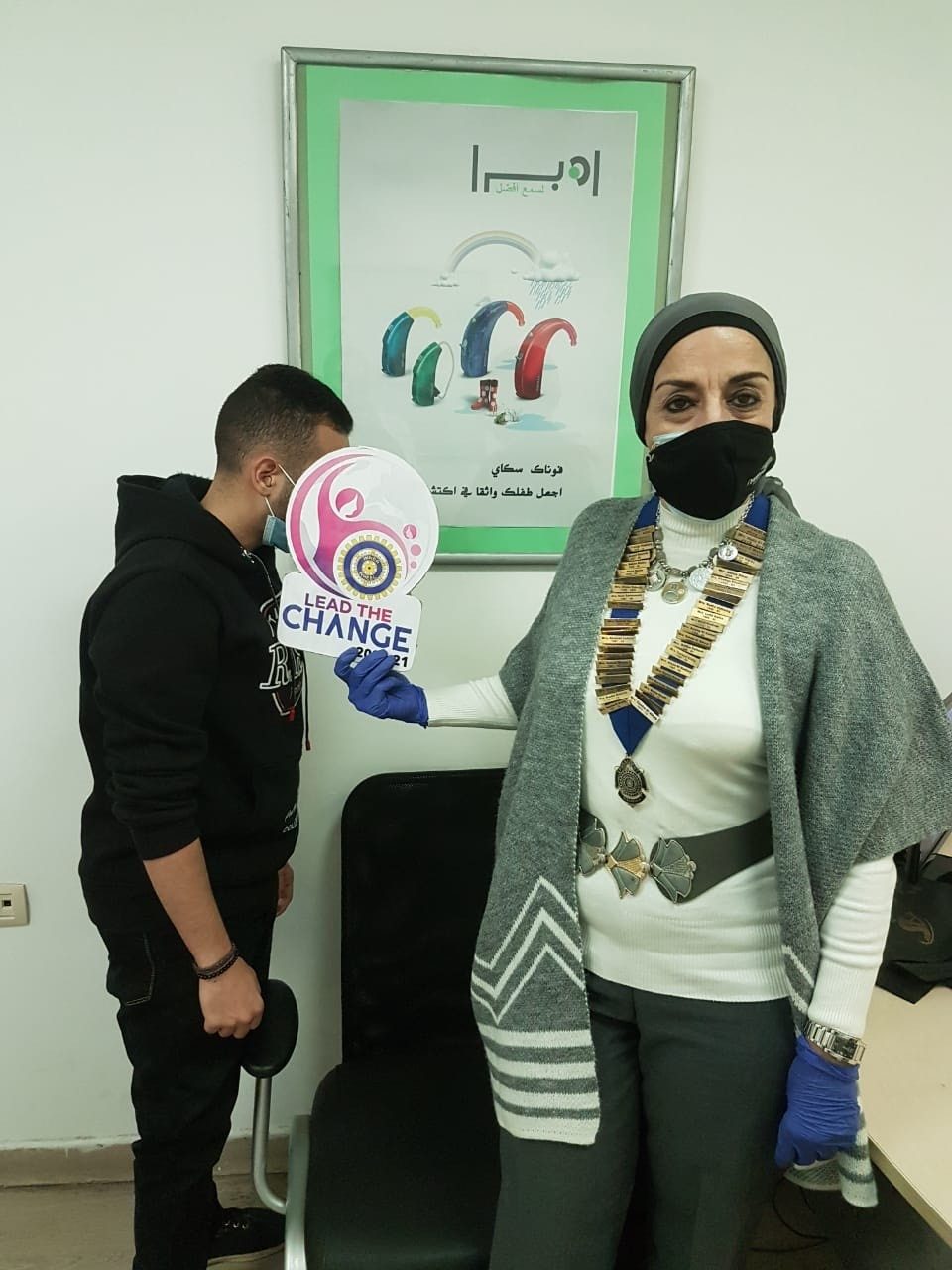 1- IWC of Alexandria President donating earpiece to a student
