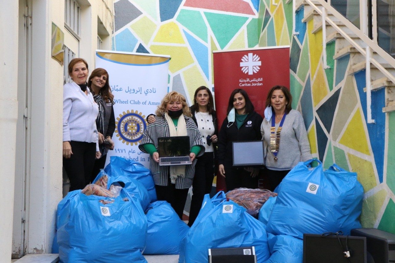 1- IWC of Amman donating computers to Caritas Association