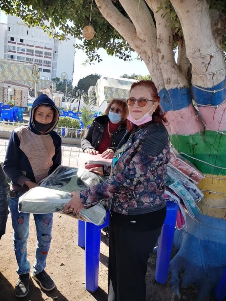 1- President of IWC of El Minya distributing blankets