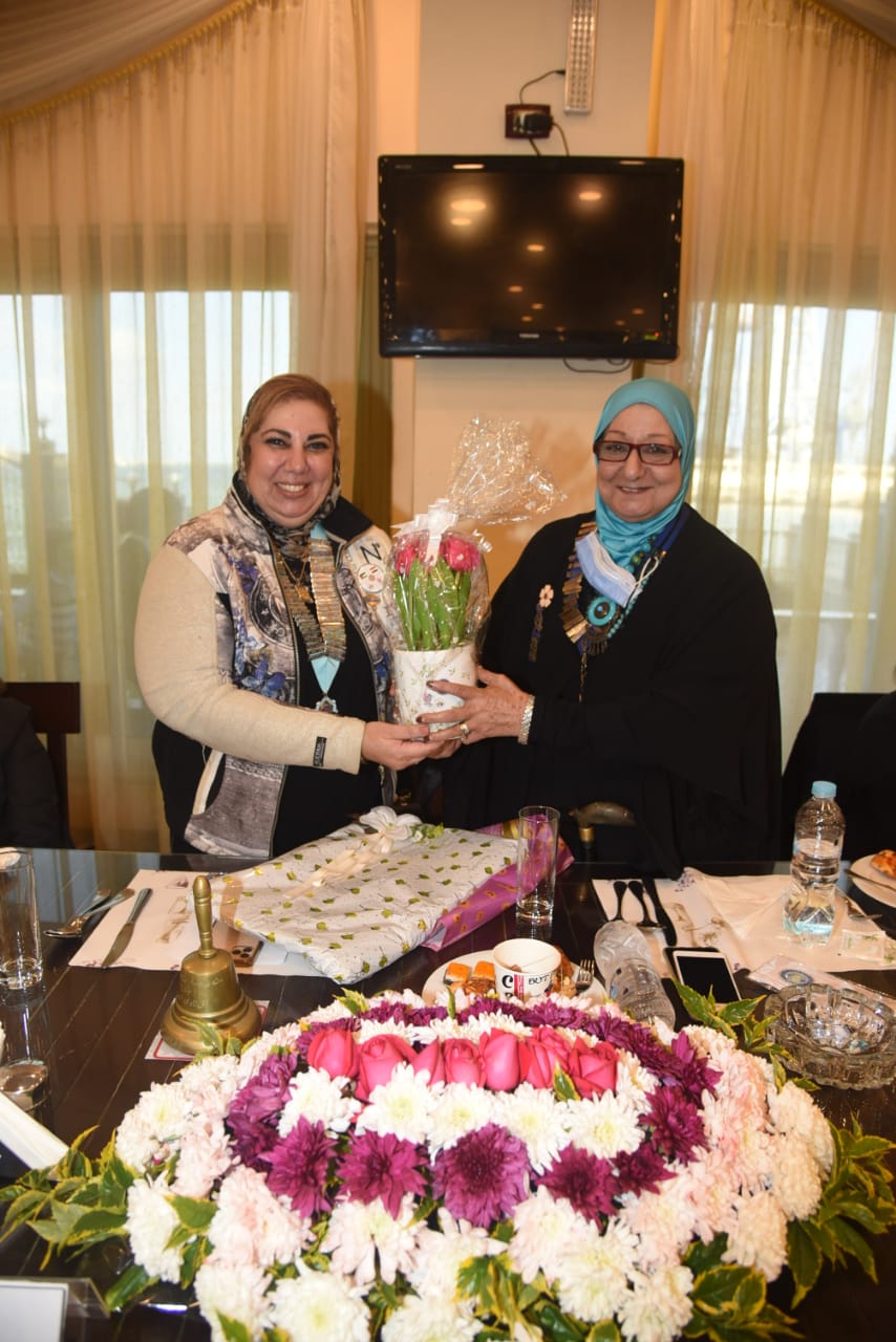 12- Mrs. Mona Aref Presenting a bouquet of flowers to President of IWC of Port Said