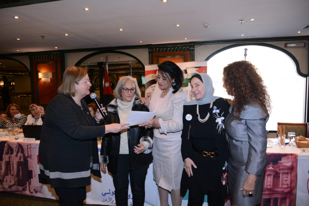 9- NR presenting the E Charter to Mrs. Nazik El Alfy President of the club
