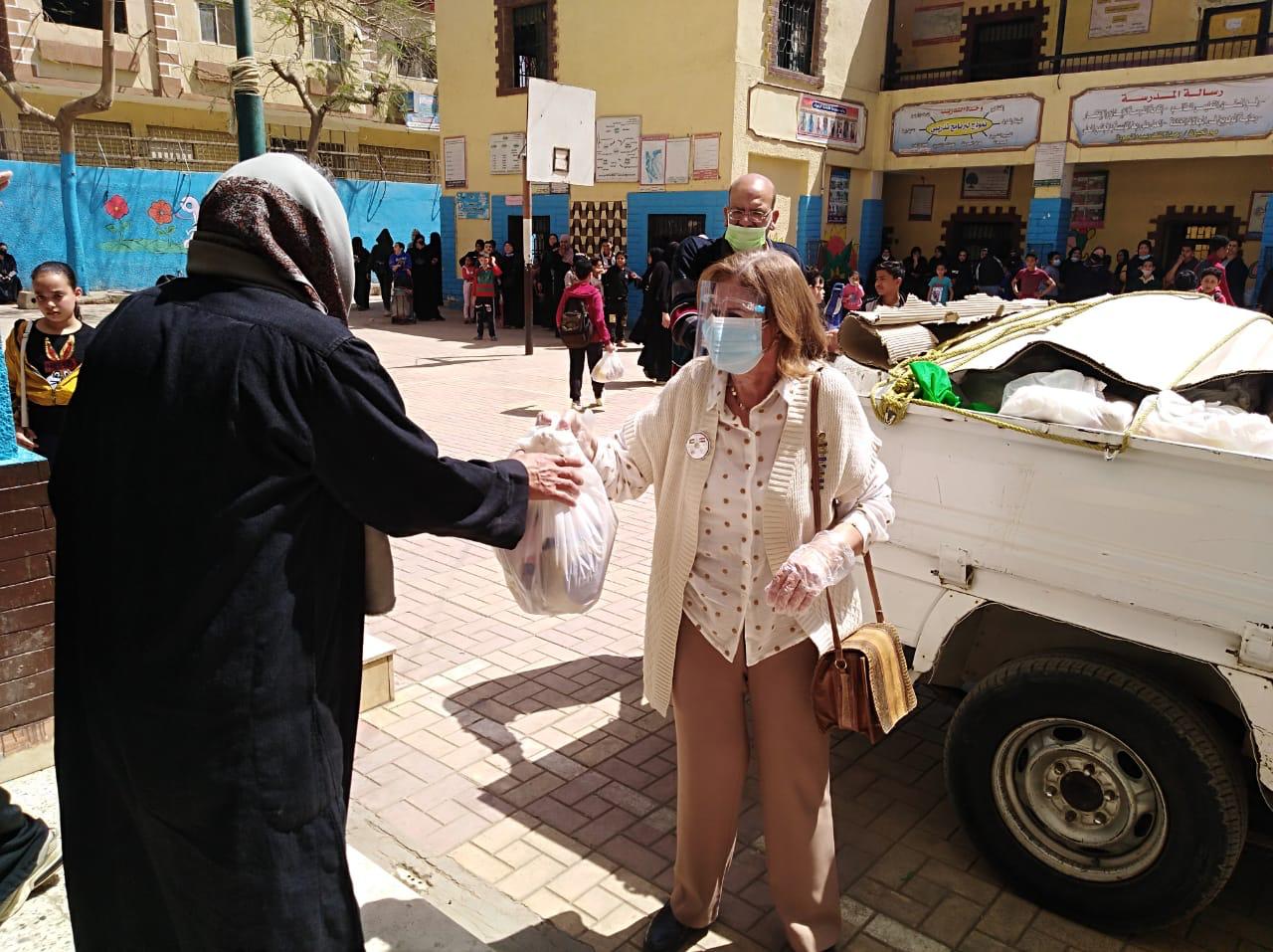 5- Mrs. Nihal El Rafei Distributing Ramadan Bag to the employee