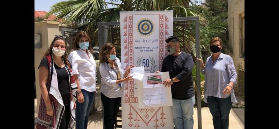 1- IWC of Amman donating shopping coupons to Wadi Moussa Charity Society