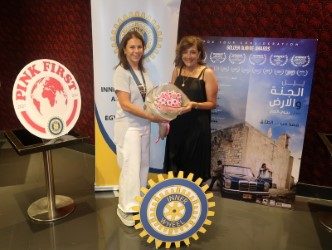 1-Lynne Farradj President of IWC of Petra offered bouquet of flowers to Najwa Najar director of the film