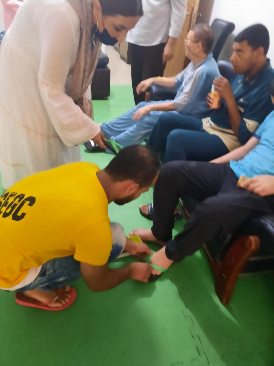 1- President of IWC of Alexandria Sporting providing Shoes for the orphanages for disabled