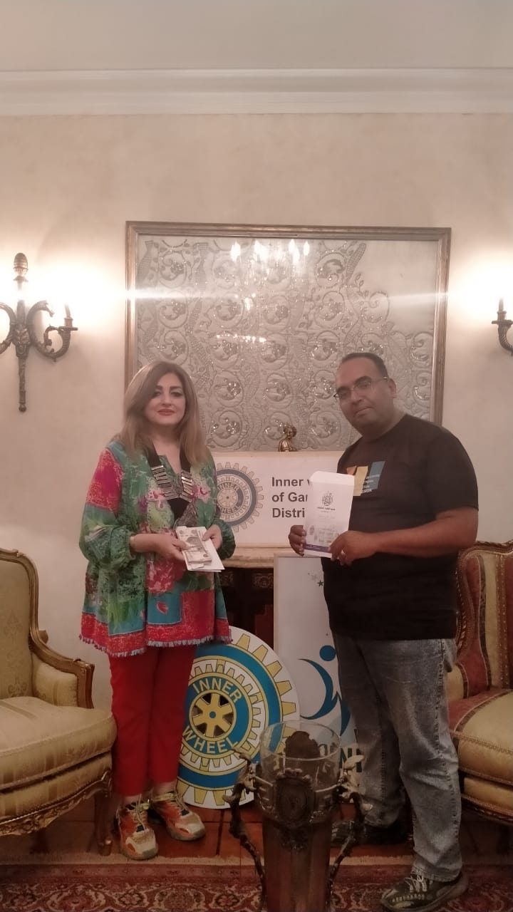 President of IWC of Garden City presented a check to “Al-Baqiyat Al-Salihat Association”for Alzheimer patients.