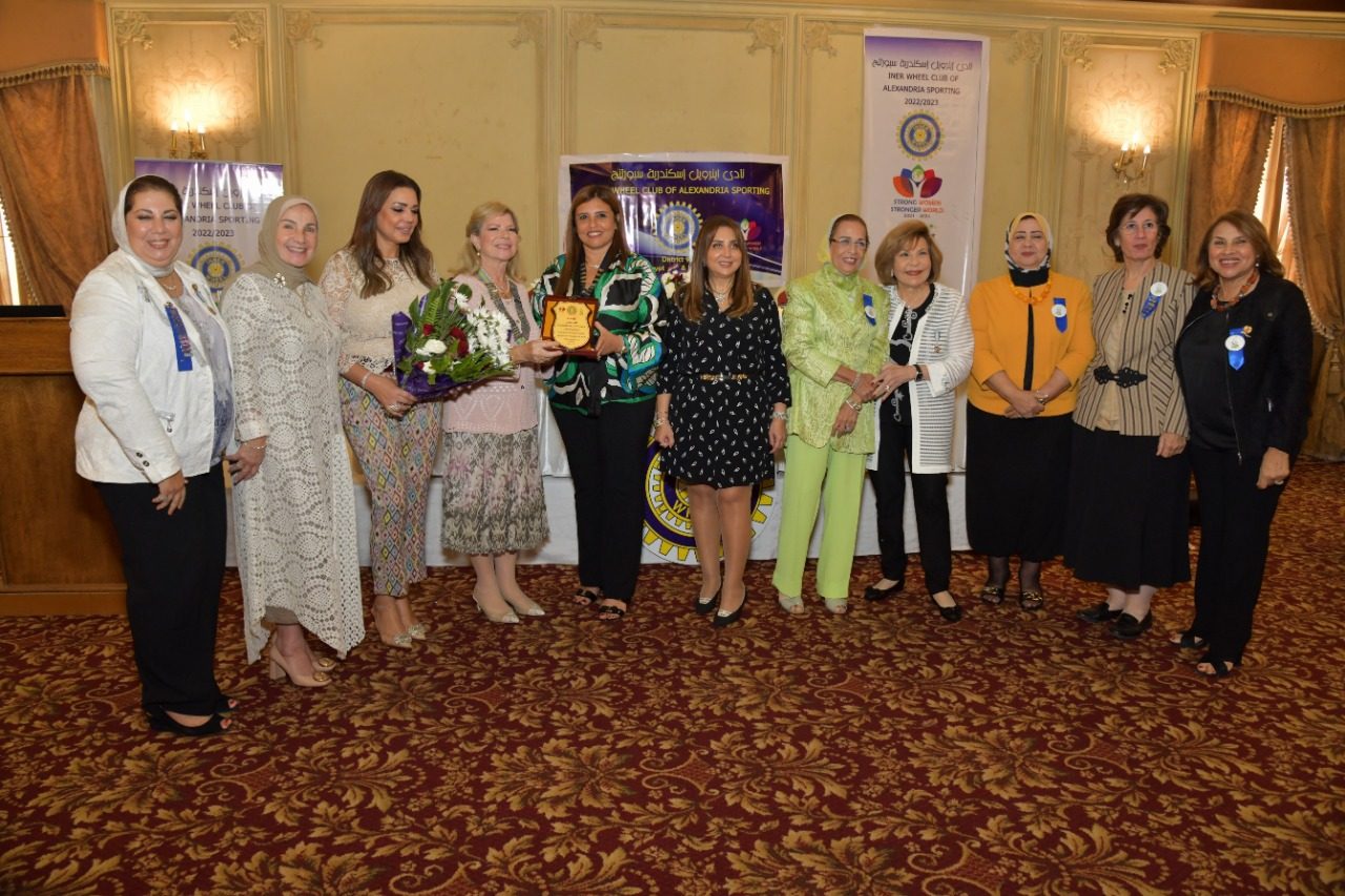1–President IWCof AlexandriaSporting presenting a Sheild of Appreciation to D 95 Chairman Mrs. Nora Fayek