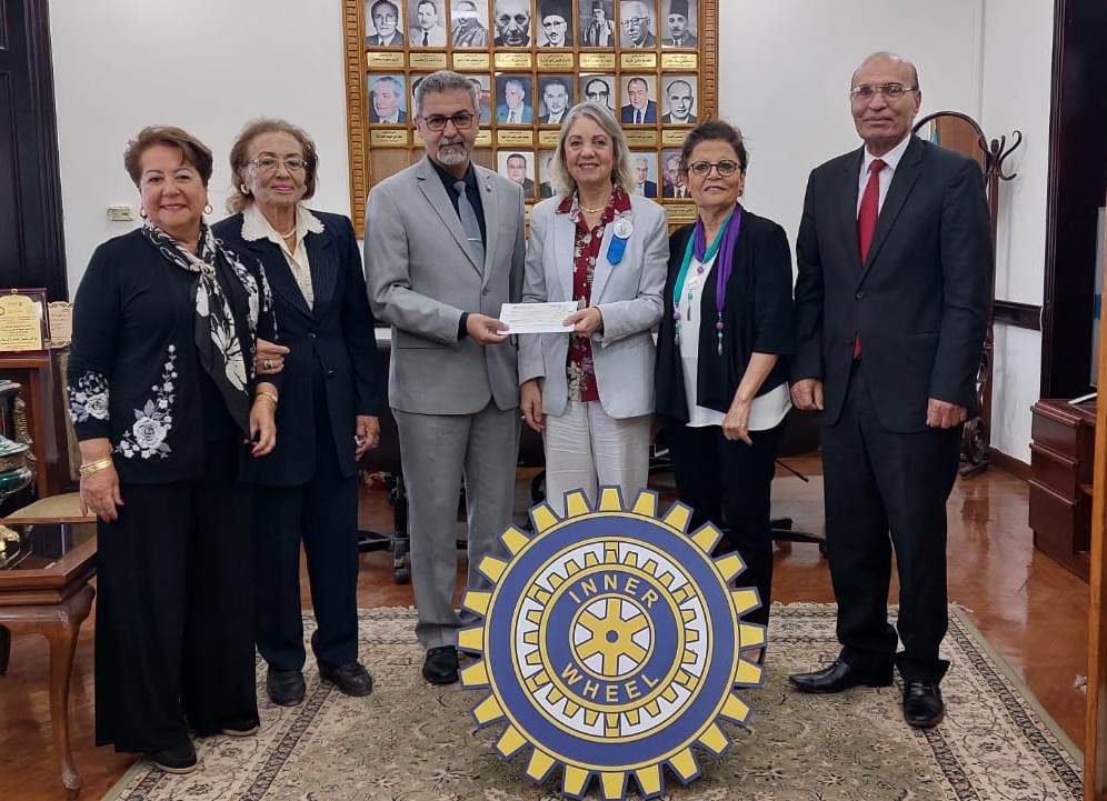 2- President of IWC of Alexandria East & Club members Provide a check to the Vice Chairman